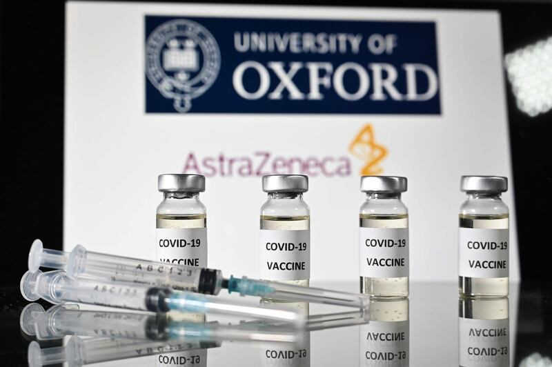(FILES) In this file photo taken on November 17, 2020 An illustration picture shows vials with Covid-19 Vaccine stickers attached and syringes, with the logo of the University of Oxford and its partner British pharmaceutical company AstraZeneca. The University of Oxford and drug manufacturer AstraZeneca have applied to the UK health regulator for permission to roll out their Covid-19 vaccine, Health Minister Matt Hancock said on December 23, 2020. "I'm delighted to be able to tell you that the Oxford AstraZeneca vaccine developed here in the UK has submitted its full data package to the MHRA for approval," he said.  / AFP / JUSTIN TALLIS
