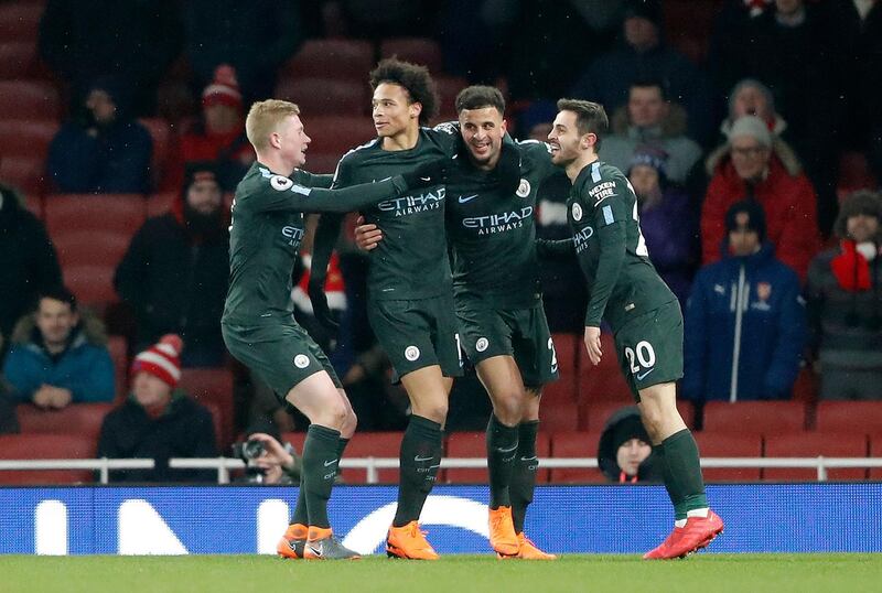 Manchester City's Leroy Sane, second left, celebrates with teammates after scoring his side's third goal during the English Premier League soccer match between Arsenal and Manchester City at the Emirates stadium in London, Thursday, March 1, 2018.(AP Photo/Frank Augstein)