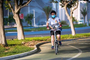 A cyclist on the bike path along the Corniche in Abu Dhabi on July 11. Victor Besa / The National 