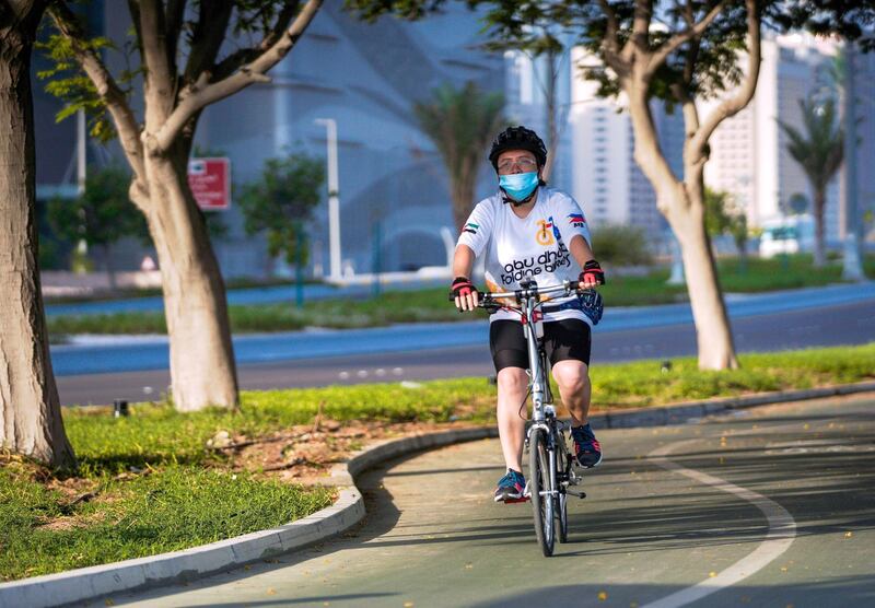 Abu Dhabi, United Arab Emirates, July 11, 2020.   
  A cyclist on the bike pathway along the Corniche with a face mask on during the Covid-19 pandemic.
Victor Besa  / The National
Section:  Standalone
Reporter: