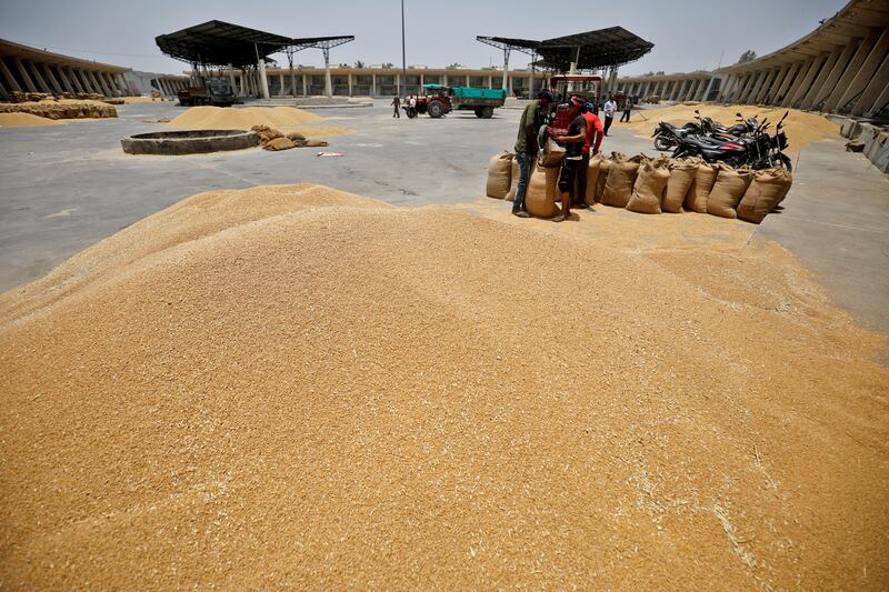 Wheat is packed into sacks outside Ahmedabad. India will give irrigation advice as a lack of winter rain threatens its wheat harvest. Reuters