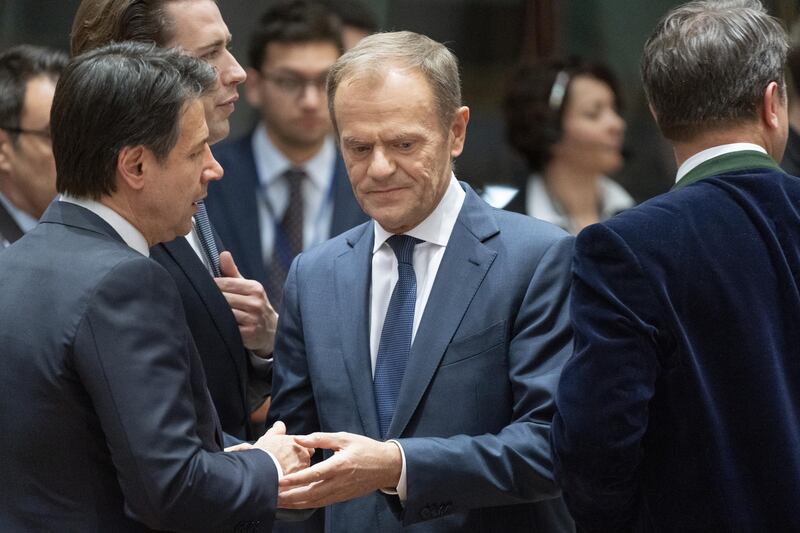 Donald Tusk, president of the European Union (EU), center, speaks with Giuseppe Conte, Italy's prime minister, left, at the start of round-table talks at a European Union (EU) leaders summit in Brussels, Belgium, on Thursday, March 21, 2019. European leaders are considering offering Theresa May extra time to avert a disastrous no-deal Brexit next week. Photographer: Jasper Juinen/Bloomberg