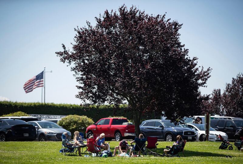 People sit together at Peace Arch Historical State Park in Blaine, Washington.  AP