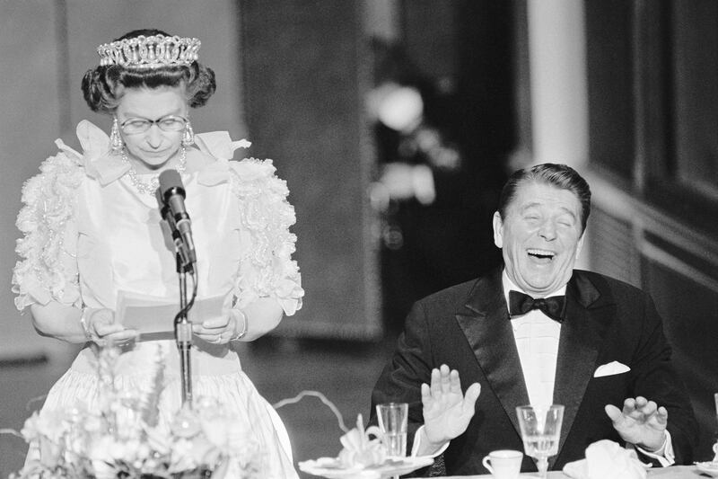 Reagan laughs following a joke by Queen Elizabeth, who commented on the lousy California weather she has experienced since her arrival in the US. Getty Images