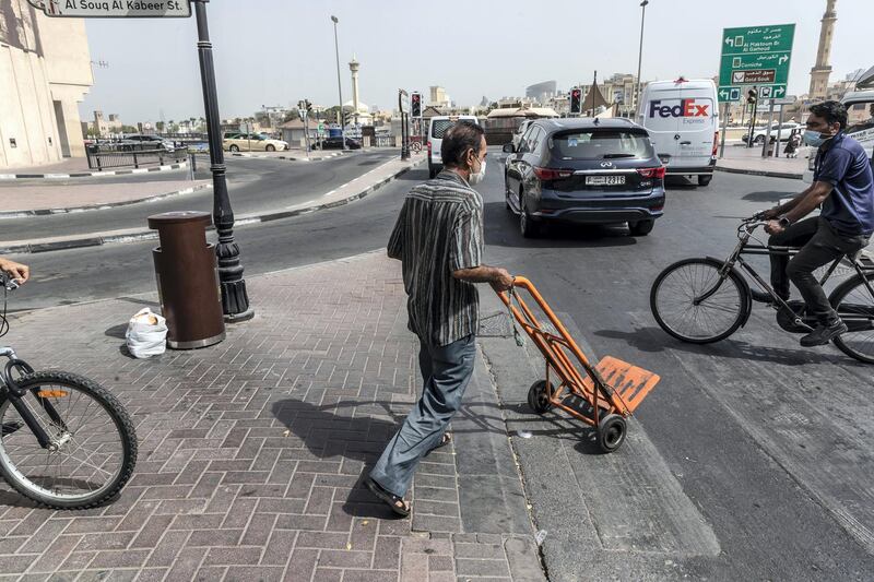 A porter pushes a trolley through the streets of Deira on June 22st, 2021. 
Antonie Robertson / The National.
Reporter: Sarwat Nasir for National