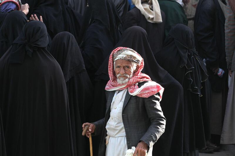 Yemenis gather to receive free bread in Sanaa, Yemen. EPA