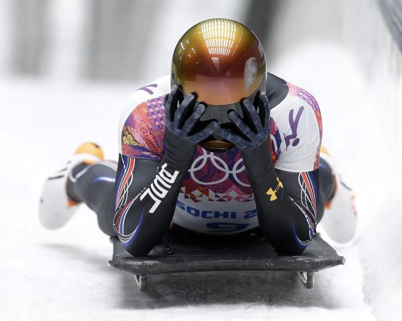 John Daly of the United States puts his head in his hands after a bad final run that dropped him out of medal contention during the men's skeleton competition on Saturday. Natacha Pisarenko / AP