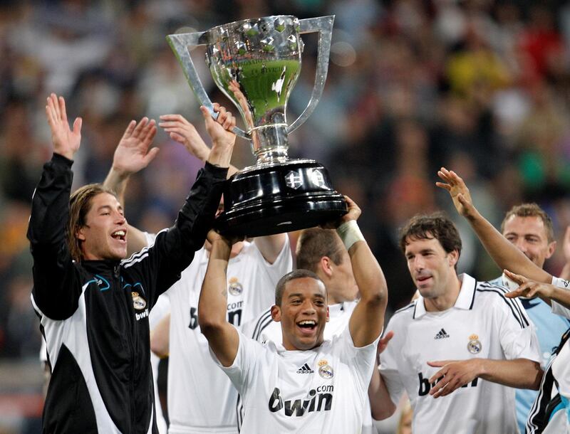 MADRID, SPAIN - MAY 18:  Marcelo (C) of Real Madrid holds aloft the La Liga trophy flanked by his teammates Sergio Ramos (L) and Ruud van Nistelrooy (R) at the end of the La Liga match between Real Madrid and Levante at the Santiago Bernabeu Stadium on May 18, 2008 in Madrid, Spain.  (Photo by Jasper Juinen/Getty Images)