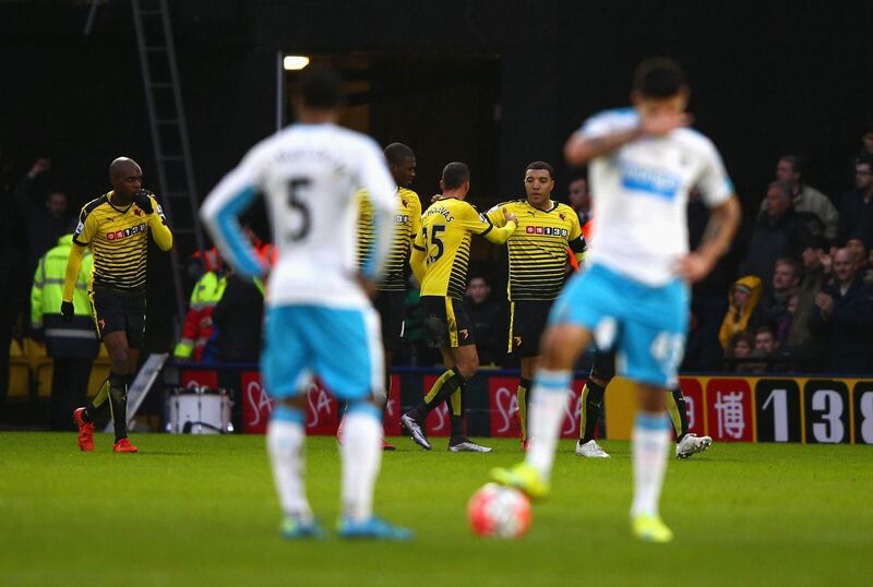 WATFORD, ENGLAND - JANUARY 09: Troy Deeney of Watford celebrates scoring his team's first goal with his team mates while Newcastle United player react during the Emirates FA Cup Third Round match between Watford and Newcastle United at Vicarage Road on January 9, 2016 in Watford, England.  (Photo by Ian Walton/Getty Images)