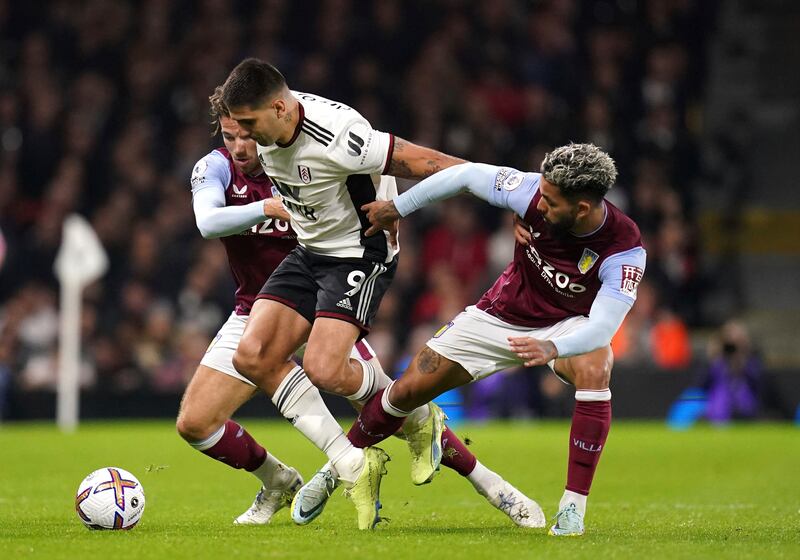 Aston Villa's Douglas Luiz, right, and Fulham's Aleksandar Mitrovic battle for the ball. PA 