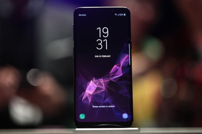 A Galaxy S9 smartphone stands on display during a Samsung Electronics Co. 'Unpacked' launch event ahead of the Mobile World Congress (MWC) in Barcelona, Spain, on Sunday, Feb. 25, 2018. The South Korea-based technology giant is banking on new features such as augmented reality-based emojis, camera upgrades, and stereo speakers in a form-factor similar to last year's model in order to take on Apple Inc.'s iPhone X. Photographer: Simon Dawson/Bloomberg