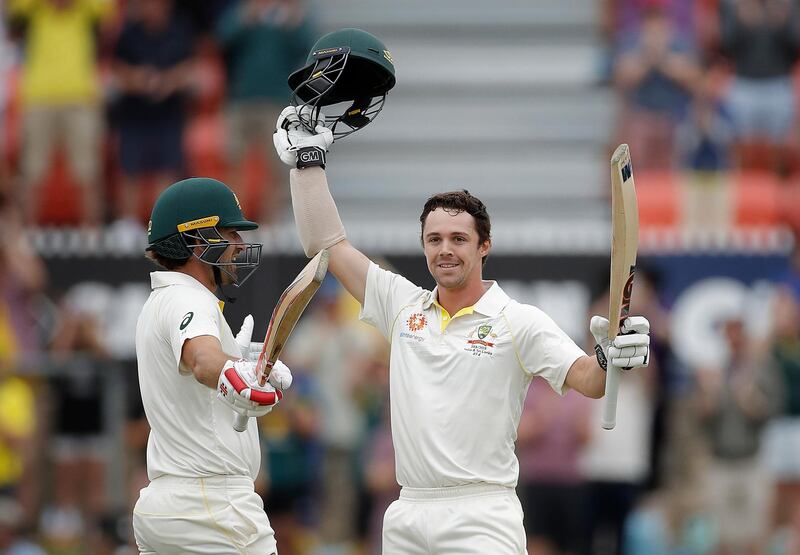 CANBERRA, AUSTRALIA - FEBRUARY 01: Travis Head of Australia celebrates with Joe Burns of Australia after reaching his maiden test century during day one of the Second Test match between Australia and Sri Lanka at Manuka Oval on February 01, 2019 in Canberra, Australia. (Photo by Ryan Pierse/Getty Images)