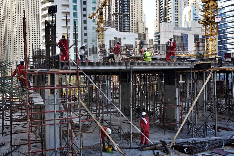 Laborers work at an under construction site near the Marina Mall in Dubai, UAE, Monday, Nov. 18, 2019. (Shruti Jain / The National)