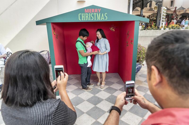 DUBAI, UNITED ARAB EMIRATES. 25 DECEMBER 2018. Coverage of Christmas Day Mass at St Francis Church in Jebel Ali. Chruch goers take pictures of themselves and family outside the church. (Photo: Antonie Robertson/The National) Journalist: Patrick Ryan. Section: National.