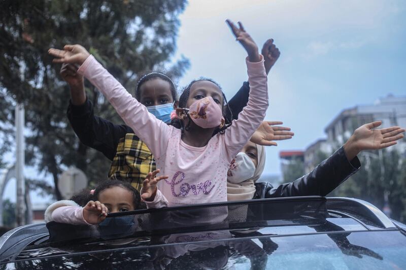 Ethiopian citizens celebrate the successful filling of the Grand Ethiopian Renaissance Dam (GERD) as the dam's first two turbines' electricity production is tested, in Addis Ababa, Ethiopia, on August 2, 2020. GERD has been a source of tension in the Nile River basin ever since Ethiopia broke ground on it in 2011. Egypt and Sudan view the dam as a threat to vital water supplies, while Ethiopia considers it crucial for its electrification and development. / AFP / Amanuel SILESHI
