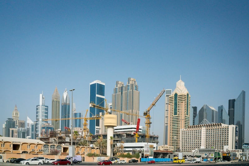 Construction cranes sit above a devlopment area beside a highway in the City Walk district of Dubai, United Arab Emirates, on Tuesday, Sept. 12, 2017. Dubai residential property prices and rents are set to fall further as losses of high-paying jobs and dwindling household incomes boost vacancies across the city, according to Phidar Advisory. Photographer: Tasneem Alsultan/Bloomberg