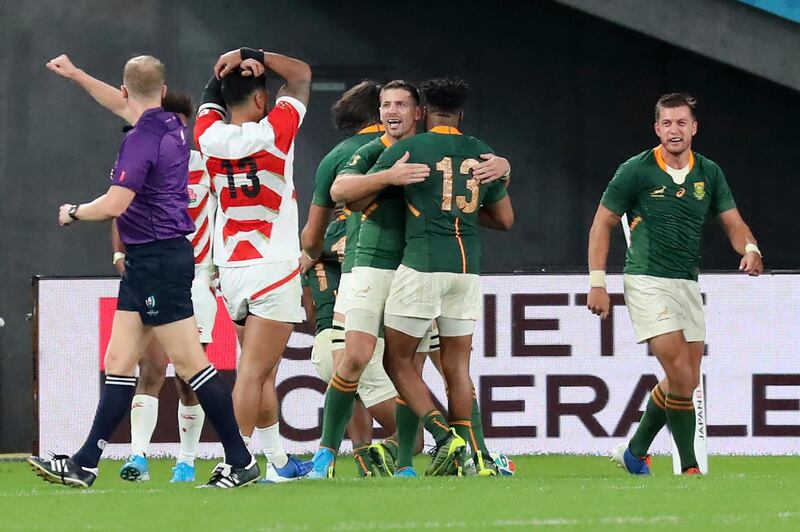 South Africa players celebrate as South Africa's Makazole Mapimpi sacred a try during the Rugby World Cup quarterfinal match at Tokyo Stadium in Tokyo, Japan, Sunday, Oct. 20, 2019. (AP Photo/Eugene Hoshiko)