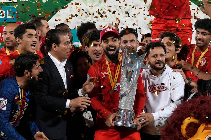Islamabad United' players and officials celebrate with trophy after winning the final of Pakistan Super League T20 cricket match against Multan Sultans, in Karachi, Pakistan, Monday March 18, 2024.  (AP Photo / Fareed Khan)