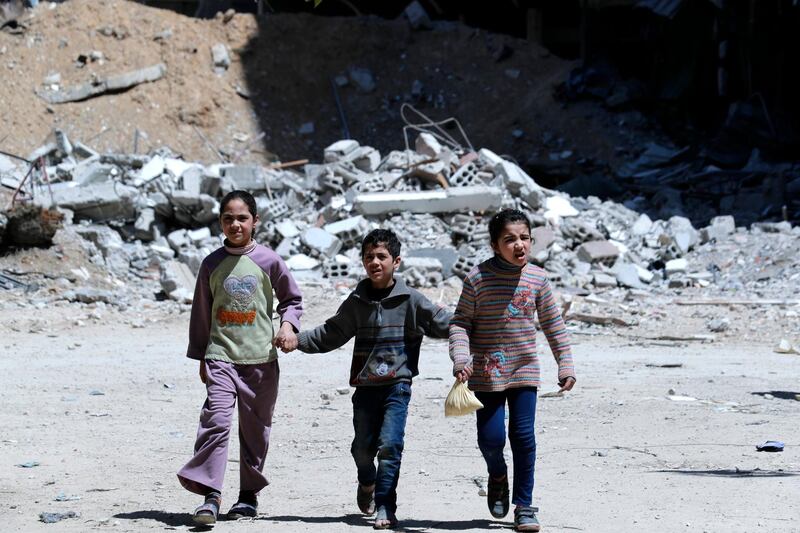 epa06673240 Children walk in Douma city, Eastern Ghouta, the countryside of Damascus, Syria, 16 April 2018. According to media reports, the Syrian army had recently driven the rebel fighters of Jaysh al-Islam (Army of Islam) out of the city. Jaysh al-Islam had control over Douma for the past six years.  EPA/STR