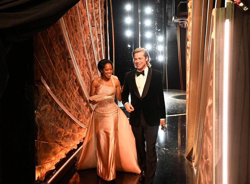 Regina King and Best Actor in a Supporting Role winner Brad Pitt walk backstage during the 92nd Oscars at the Dolby Theatre in Hollywood, California on February 9, 2020.  AFP