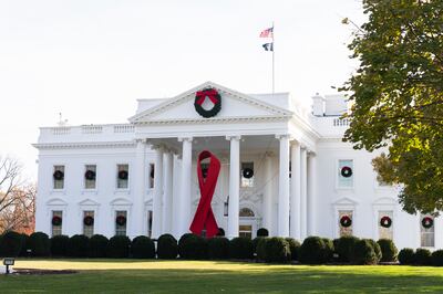 The North Portico of the White House is adorned with a huge red ribbon to commemorate the annual World Aids Day. AP
