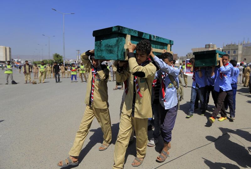 Yemeni children help carrying coffins of schoolchildren during a funeral in the capital Sanaa on April 10, 2019. Yemeni rebels held a mass funeral today for children killed in an explosion near two schools in the capital Sanaa. The explosion in the rebel-held Yemeni capital killed 14 children and wounded 16 others on April 7, the UN said. The cause remains unknown.
 / AFP / Mohammed HUWAIS
