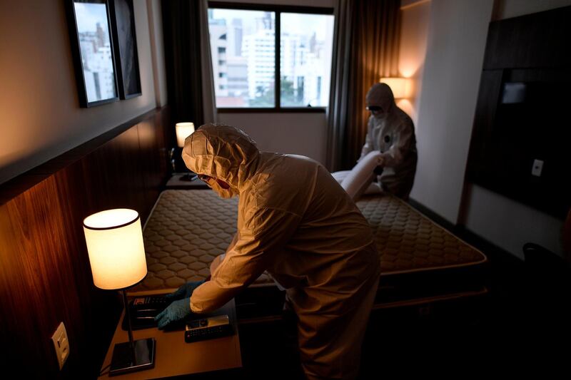 Members of the cleaning staff disinfect a room at a hotel in Belo Horizonte, Brazil, which continues to operate despite the coronavirus pandemic. AFP