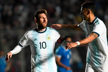 Lionel Messi, left, celebrates with Argentina teammate Matias Suarez after scoring against Nicaragua. Andres Larrovere / AFP