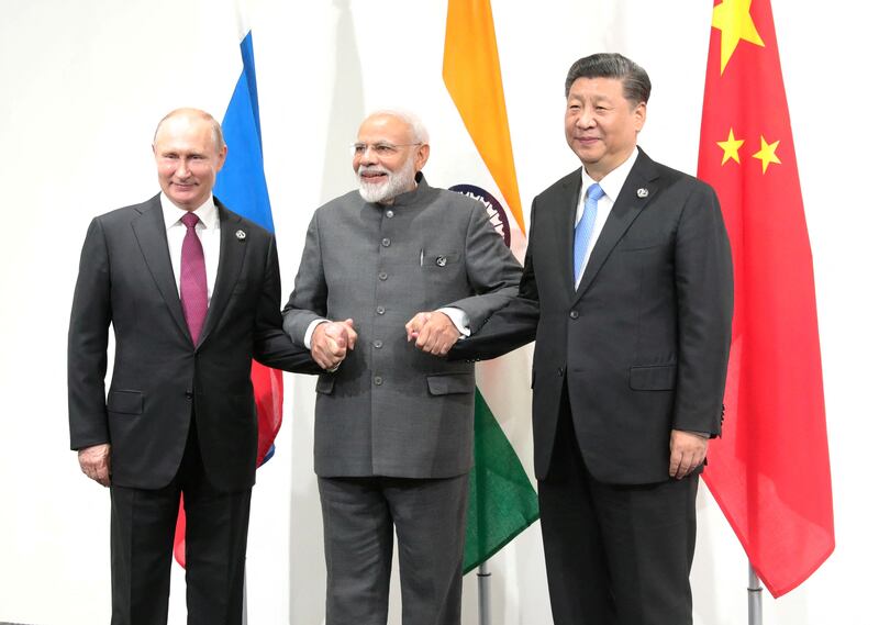 Russia's President Vladimir Putin, left, India's Prime Minister Narendra Modi, centre, and China's President Xi Jinping at the G20 summit in Osaka, Japan, in 2019. Reuters