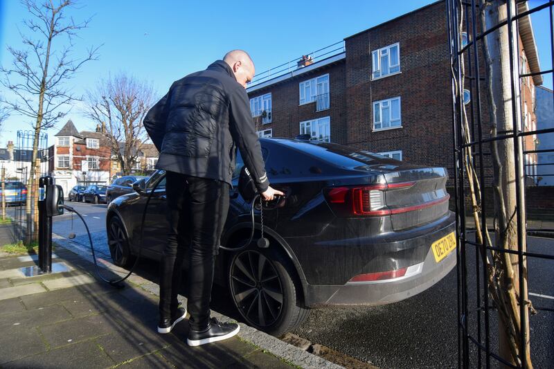 Connected Kerb chief executive Chris Pateman-Jones plugs his electric car into one of the company's on-street chargers in London. Reuters