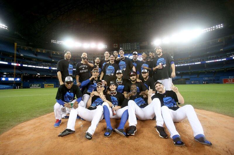 The Toronto Blue Jays pose for a team photo after their 6-3 win on Wednesday night over the Texas Rangers to reach the American League Championship Series. Tom Szczerbowski / Getty Images / AFP