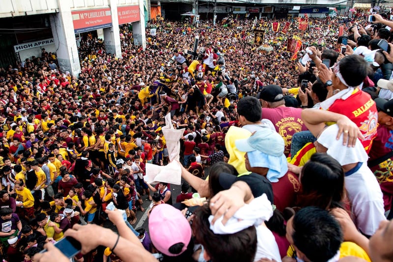 Catholic devotees transport the carriage of the Black Nazarene statue. AFP