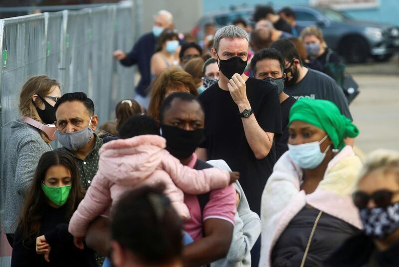 People queue at a test centre following an outbreak of the coronavirus disease (COVID-19) in Southend-on-sea, Britain. REUTERS