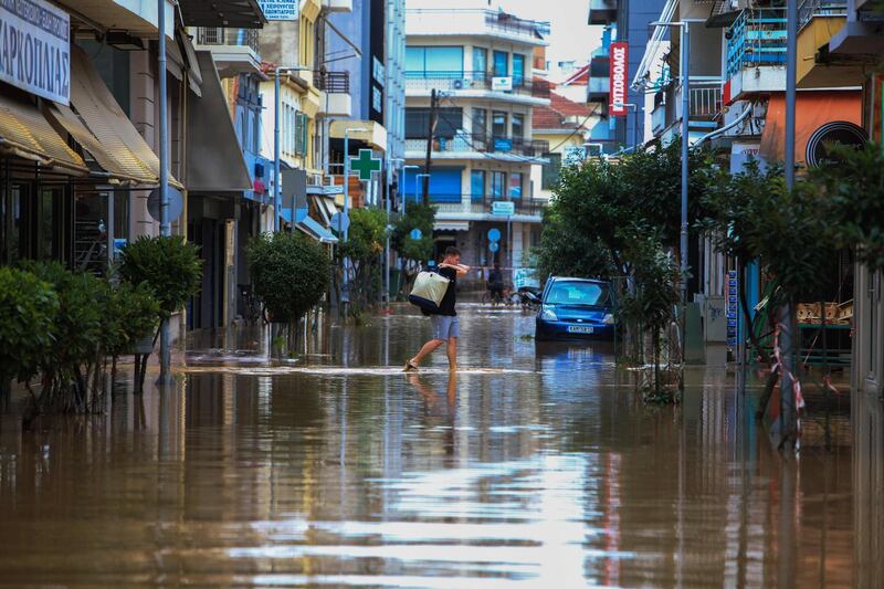 A man walks in a flooded road caused by the Mediterranean hurricane Ianos in Karditsa, central Greece. AFP