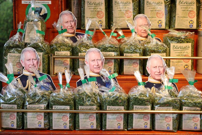 Cardboard cut-outs of King Charles among packages of wild garlic at the Wittenbergplatz food market in Berlin. AFP
