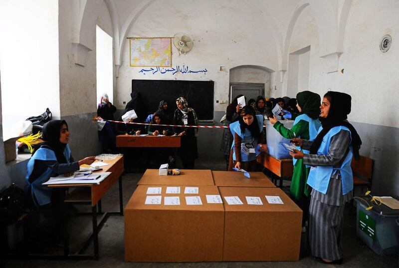 Afghan election monitors count the votes at a polling station in the northwestern city of Herat on April 5.  Aref Karimi / AFP Photo

