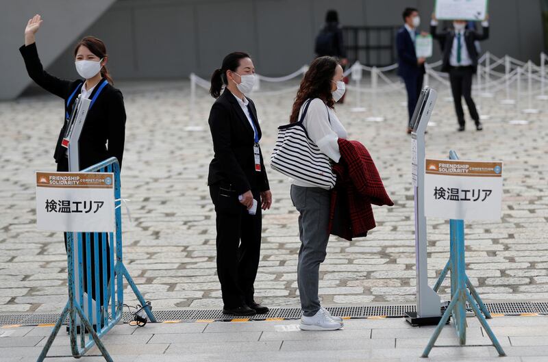 A visitor wearing a protective mask has her temperature checked at a machine at the entrance of the venue of Friendship and Solidarity Competition, the first international event at a Tokyo Olympic venue since the Games were postponed in March. Reuters