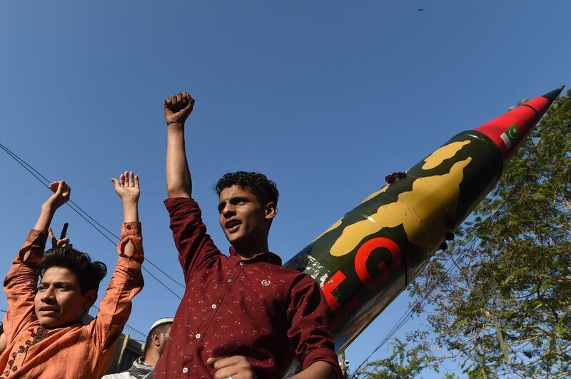 Supporters of the All Pakistan Muslim League Quid (APMLQ) chant slogans beside a replica of a missile during an anti-India protest, in Karachi on March 5, 2019. Tensions between India and Pakistan raged on March 2 as heavy firing by their armies killed at least seven people on either side of their fiercely disputed Kashmir border. / AFP / ASIF HASSAN
