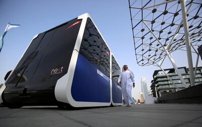 A man walks past the world's first autonomous pods which was launched by the Roads and Transport Authority of Dubai in Dubai, United Arab Emirates February, 28, 2018. Picture taken February, 28, 2018. REUTERS/Satish Kumar - RC1BA7C68C00