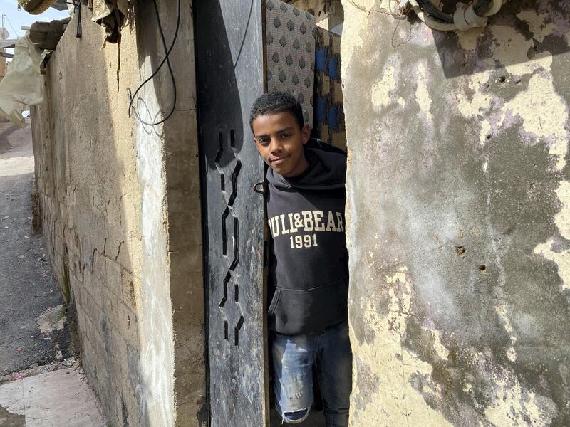 A young man looks out from his front door in Jerash refugee camp. Amy McConaghy / The National