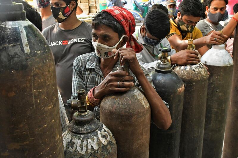 People queue to refill oxygen cylinders for Covid-19 patients at a centre in India's capital New Delhi.