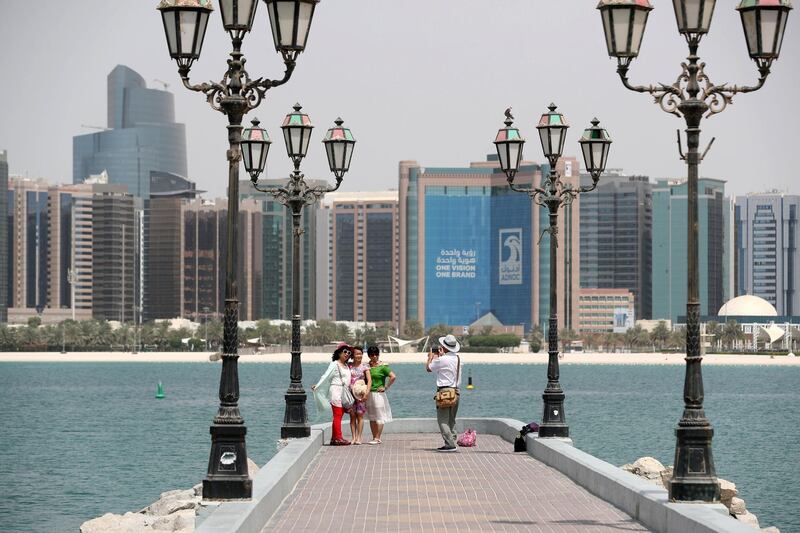 Abu Dhabi, United Arab Emirates - June 5th, 2018: Standalone. Tourists have their photographs taken in Abu Dhabi. Tuesday, June 5th, 2018 at Corniche, Abu Dhabi. Chris Whiteoak / The National