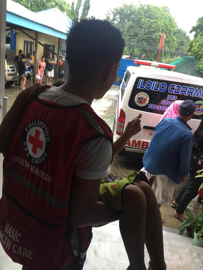 A Philippine Red Cross worker carries a survivor to an ambulance. EPA / Philippine Red Cross