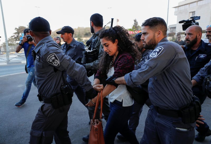 Israeli security forces detain a Palestinian woman during a protest held after a detainee suspected of killing an Israeli teenager in a bomb attack was hospitalised during interrogation, in Jerusalem. Reuters