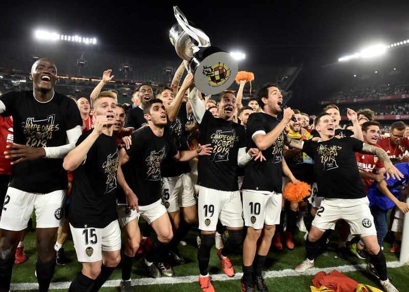 Valencia's players celebrate with the Copa del Rey trophy  after beating Barcelona 2-1. EPA