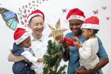 Tuan Phan of SimplyFI.org with his wife Betty Omodamwen and their children Morris, 1, and Alma, 2, at their Abu Dhabi home. Mr Phan limits Christmas gifts to his children to one toy each, under Dh50, and one small present each of Dh100. Chris Whiteoak / The National