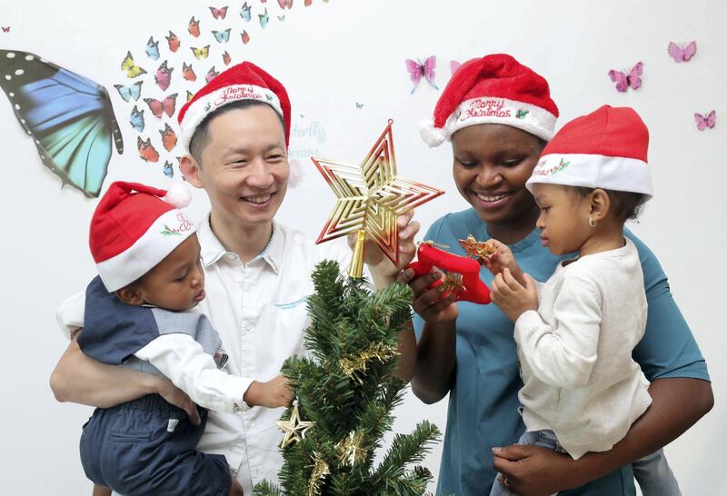 Abu Dhabi, United Arab Emirates - December 05, 2018: Tuan Phan with wife Betty Omodamwen and children Morris 1 and Alma 2. Tuan is a meteorologist by day who blogs for non-profit community SimplyFI.org, which encourages investors to follow the investment principles established by Jack Bogle, the founder of Vanguard. He is one of the personal finance bloggers talking about their Christmas and Christmas advice to avoid blowing your bank account during the festive season. Wednesday the 5th of December 2018 on Yas Island, Abu Dhabi. Chris Whiteoak / The National