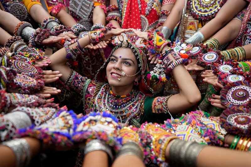 Women wearing traditional attire dance in formation for the garba, the traditional dance of Gujarat state, ahead of the Hindu festival of Navratri, in Ahmedabad, India. AP