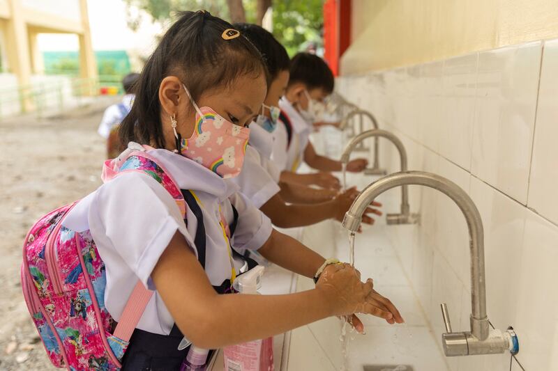 Students wash their hands to help keep Covid-19 at bay. Reuters