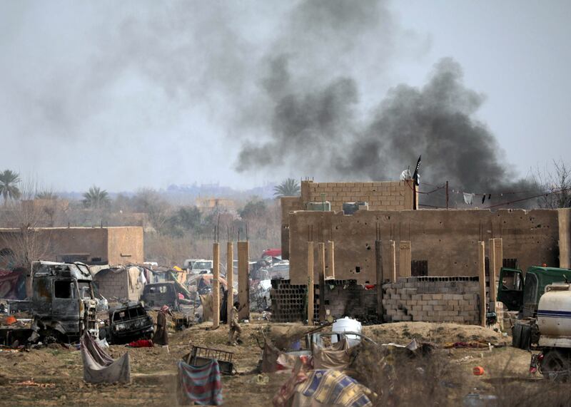 Islamic State members walk in the last besieged neighborhood in the village of Baghouz, Deir Al Zor province, Syria March 10, 2019. REUTERS/Rodi Said